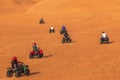 Quad Biking Dubai Adventure Tour Ã¢â¬âTourists having fun on Quad Bike Riding in dunes of Dubai. Royalty Free Stock Photo